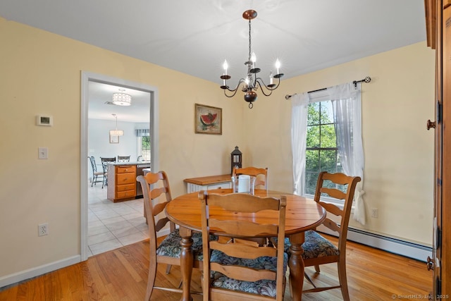 62 Peach Tree Ln, Berlin, CT 06037 - dining room featuring baseboard heating, a chandelier, and light wood finished floors