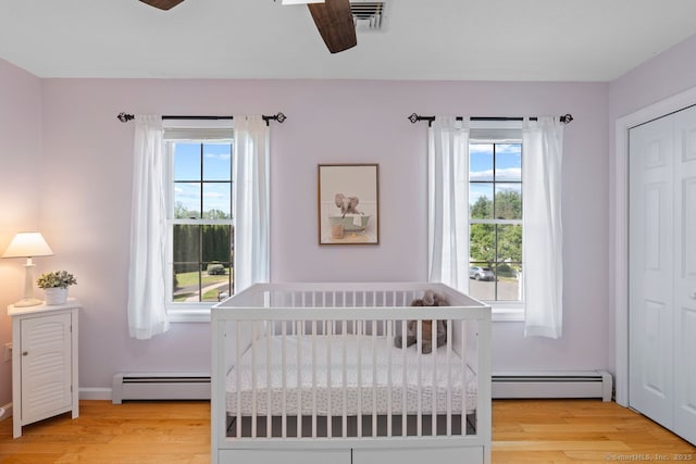 62 Peach Tree Ln, Berlin, CT 06037 - bedroom with a baseboard heating unit, light wood-style flooring, and multiple windows