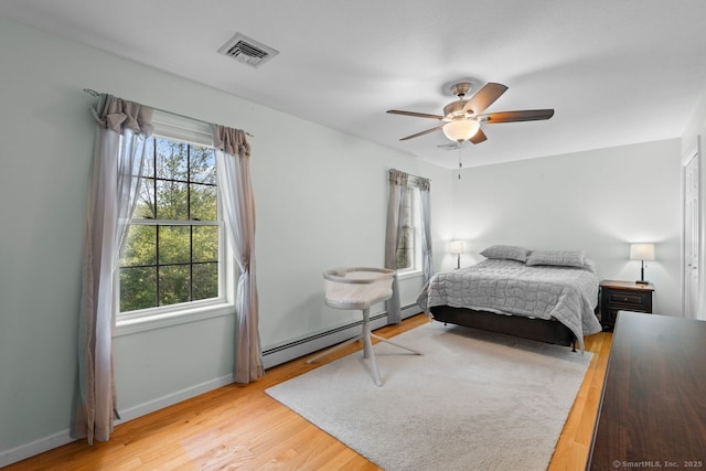 62 Peach Tree Ln, Berlin, CT 06037 - bedroom with a baseboard radiator, multiple windows, wood finished floors, and ceiling fan