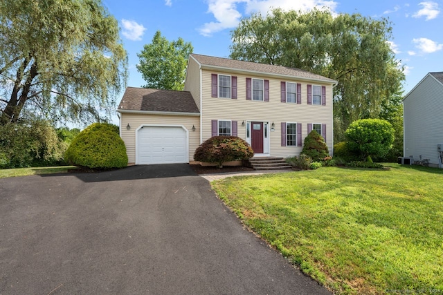 62 Peach Tree Ln, Berlin, CT 06037 - colonial-style house featuring an attached garage, driveway, and a front yard