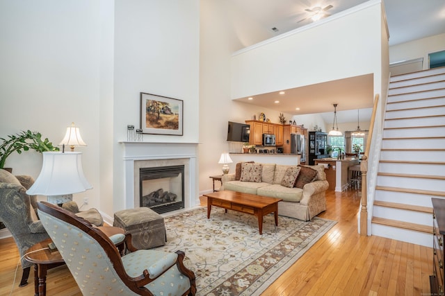 802 Dzen Way Unit 802, South Windsor, CT 06074 - living room with stairs, light wood-type flooring, and a glass covered fireplace