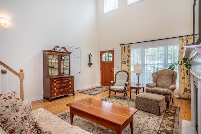 802 Dzen Way Unit 802, South Windsor, CT 06074 - living room featuring light wood finished floors, plenty of natural light, a towering ceiling, and stairway