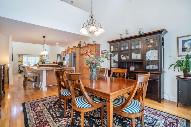 802 Dzen Way Unit 802, South Windsor, CT 06074 - dining room featuring light wood-style flooring, a chandelier, and a towering ceiling