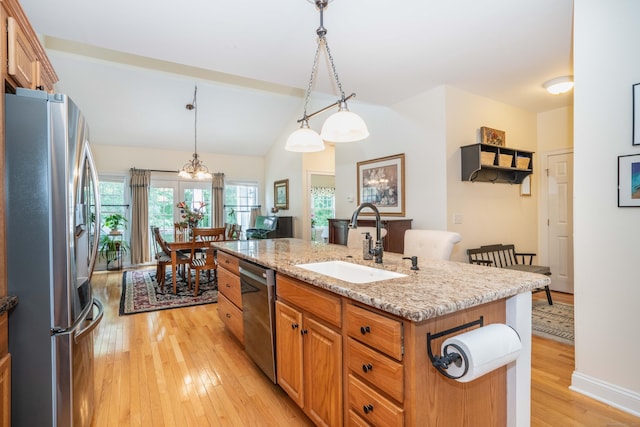 802 Dzen Way Unit 802, South Windsor, CT 06074 - kitchen featuring stainless steel appliances, light wood finished floors, an island with sink, light stone counters, and hanging light fixtures