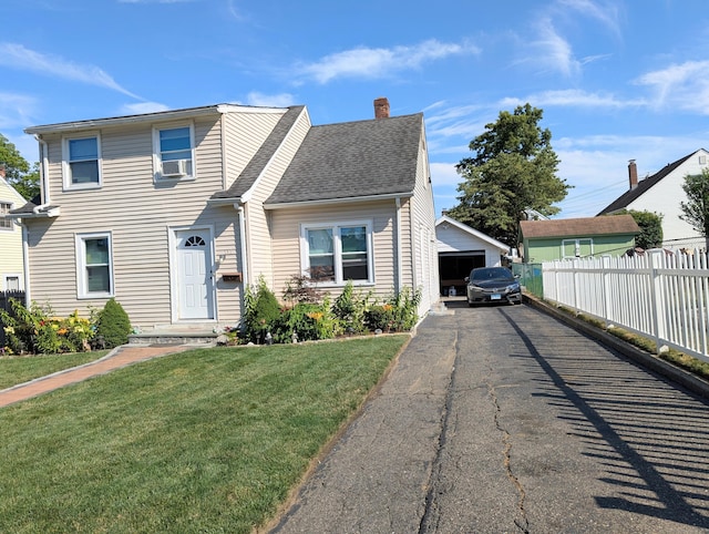 715 Burnsford Ave, Bridgeport, CT 06606 - view of front facade with a garage, a chimney, cooling unit, roof with shingles, and an outdoor structure