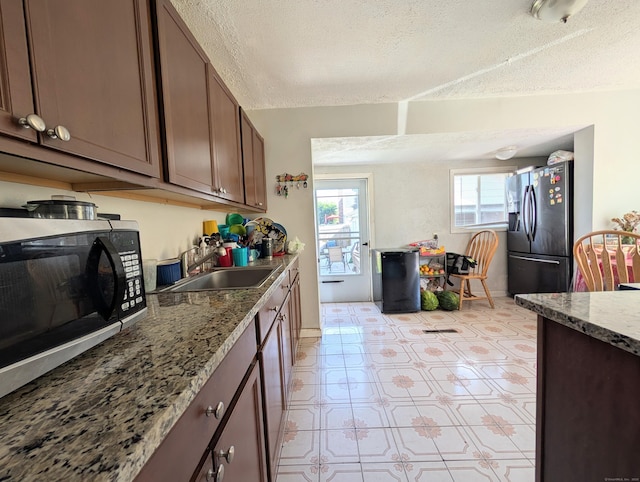 715 Burnsford Ave, Bridgeport, CT 06606 - kitchen featuring stainless steel appliances, a textured ceiling, and stone counters