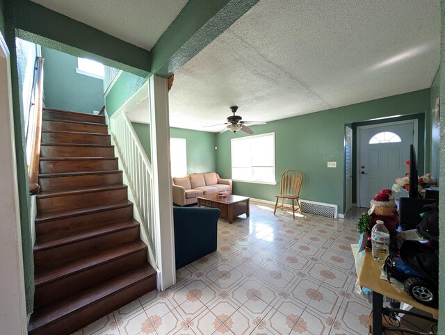 715 Burnsford Ave, Bridgeport, CT 06606 - living room with stairs, a ceiling fan, a textured ceiling, and light flooring