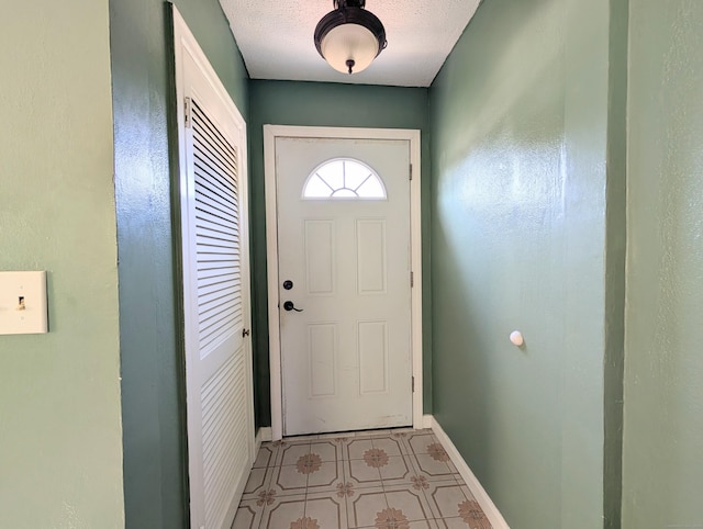 715 Burnsford Ave, Bridgeport, CT 06606 - doorway to outside featuring baseboards and a textured ceiling
