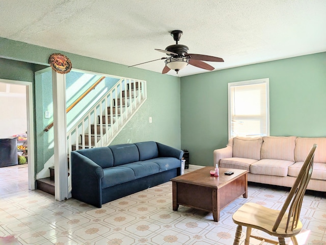 715 Burnsford Ave, Bridgeport, CT 06606 - living area featuring healthy amount of natural light, stairs, ceiling fan, and a textured ceiling