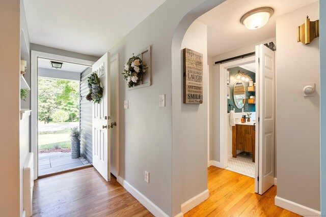 216 Main St, Glastonbury, CT 06073 - foyer entrance with light wood-style floors and arched walkways