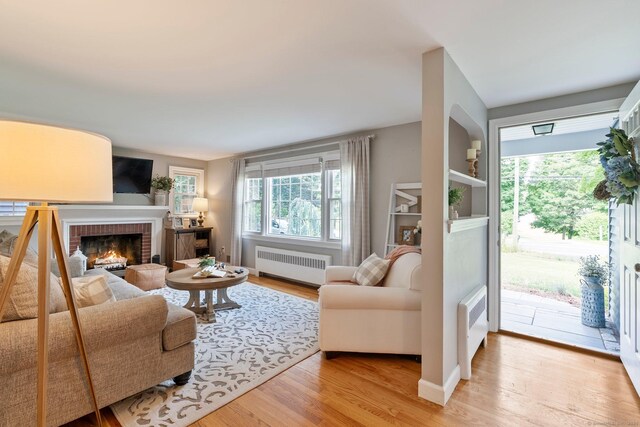 216 Main St, Glastonbury, CT 06073 - living room with radiator, light wood-type flooring, and a fireplace