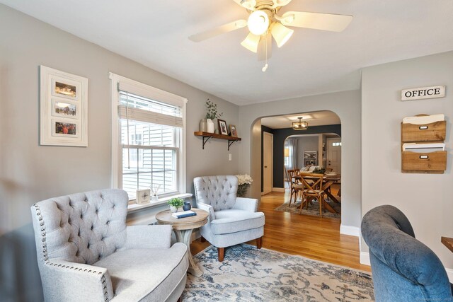 216 Main St, Glastonbury, CT 06073 - living area featuring arched walkways, wood finished floors, and a ceiling fan