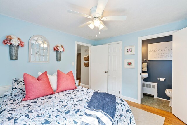 216 Main St, Glastonbury, CT 06073 - bedroom with radiator, wood finished floors, ensuite bath, and ceiling fan