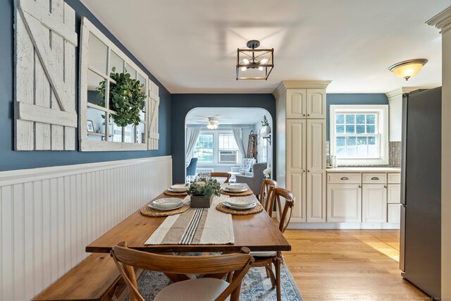 216 Main St, Glastonbury, CT 06073 - dining space with light wood-style floors, a chandelier, cooling unit, and wainscoting