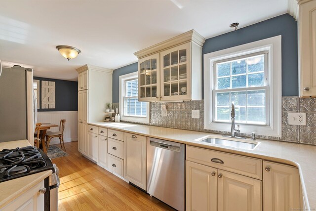 216 Main St, Glastonbury, CT 06073 - kitchen with stainless steel dishwasher, freestanding refrigerator, light countertops, light wood-type flooring, and range