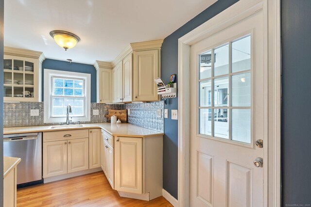 216 Main St, Glastonbury, CT 06073 - kitchen with stainless steel dishwasher, tasteful backsplash, light countertops, and light wood-type flooring