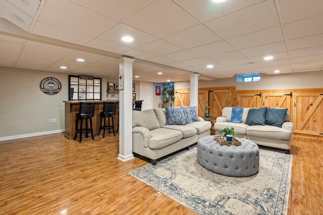 216 Main St, Glastonbury, CT 06073 - living area featuring bar area, wood finished floors, a paneled ceiling, and recessed lighting