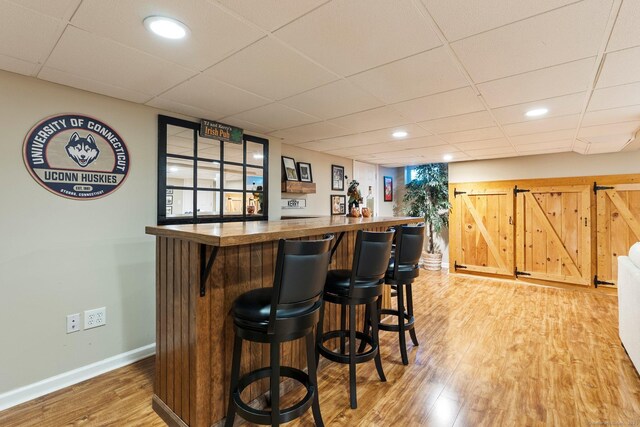 216 Main St, Glastonbury, CT 06073 - indoor bar with light wood-style flooring, a paneled ceiling, and recessed lighting