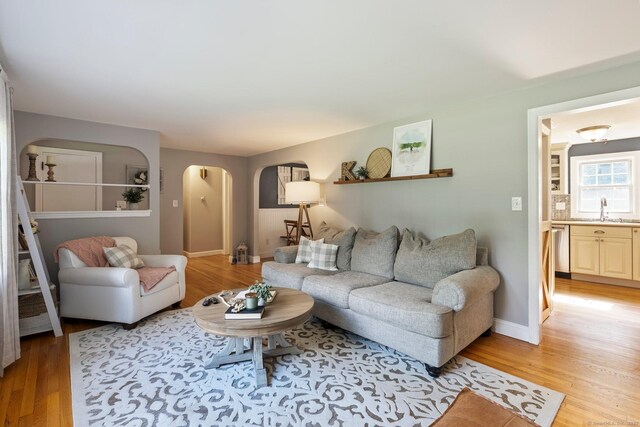 216 Main St, Glastonbury, CT 06073 - living area with arched walkways and light wood-style flooring