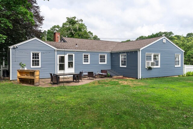 216 Main St, Glastonbury, CT 06073 - back of property featuring a chimney, a patio, a lawn, cooling unit, and roof with shingles