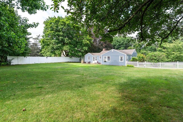 216 Main St, Glastonbury, CT 06073 - fenced backyard featuring view of wooded area