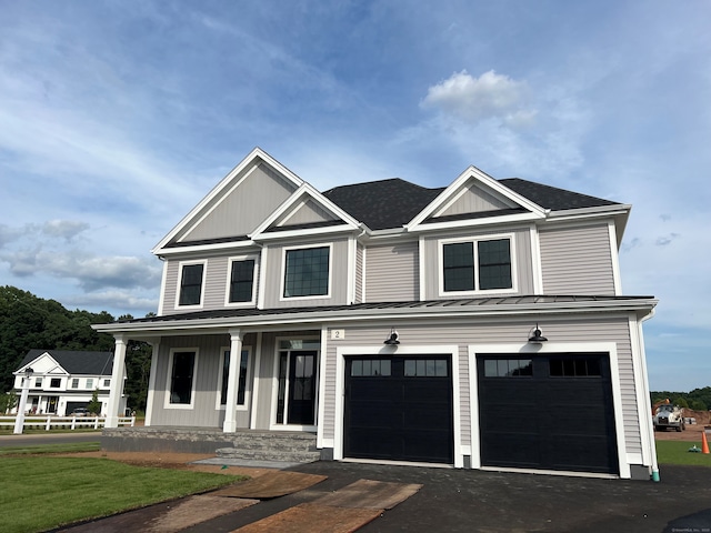 44 Primrose Ln, Cromwell, CT 06416 - view of front of home with a standing seam roof, covered porch, driveway, a metal roof, and a garage