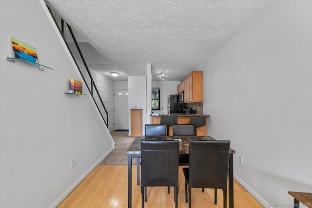 125 Olive St Apt D2, New Haven, CT 06511 - dining space with light wood-style flooring and a textured ceiling