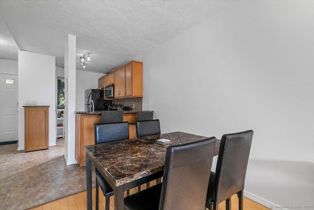 125 Olive St Apt D2, New Haven, CT 06511 - dining space with a textured ceiling and light wood-style flooring