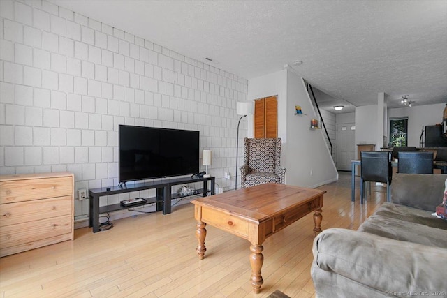 125 Olive St Apt D2, New Haven, CT 06511 - living area with light wood-style floors and a textured ceiling