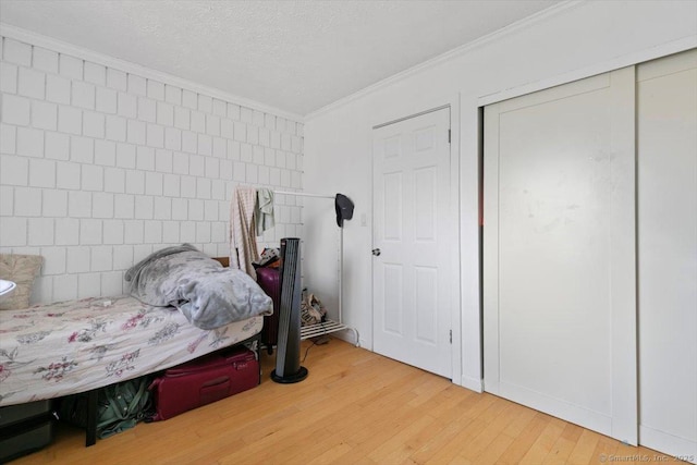 125 Olive St Apt D2, New Haven, CT 06511 - bedroom featuring crown molding, wood finished floors, a textured ceiling, and a closet