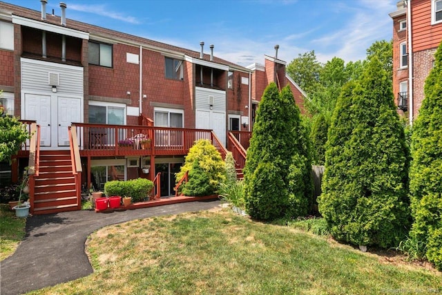 125 Olive St Apt D2, New Haven, CT 06511 - rear view of property with stairway, a wooden deck, and a lawn
