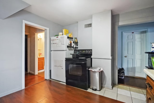 32 Williams St, Bristol, CT 06010 - kitchen with black electric range oven and freestanding refrigerator