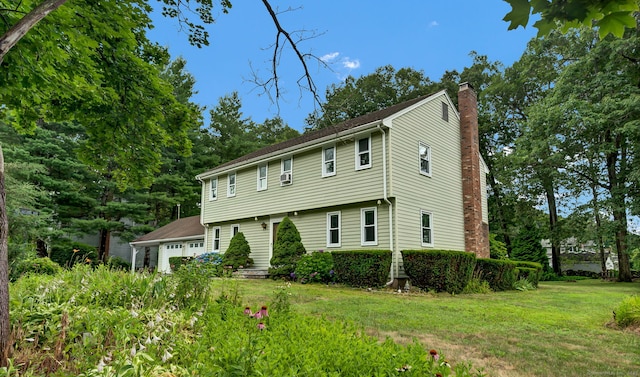 186 Wood Pond Rd, South Windsor, CT 06074 - colonial-style house with a chimney, a garage, and a front lawn