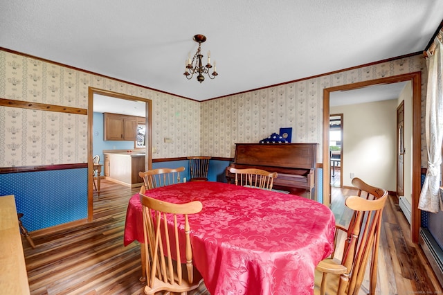 186 Wood Pond Rd, South Windsor, CT 06074 - dining room featuring wallpapered walls, hardwood / wood-style flooring, ornamental molding, a baseboard radiator, and wainscoting