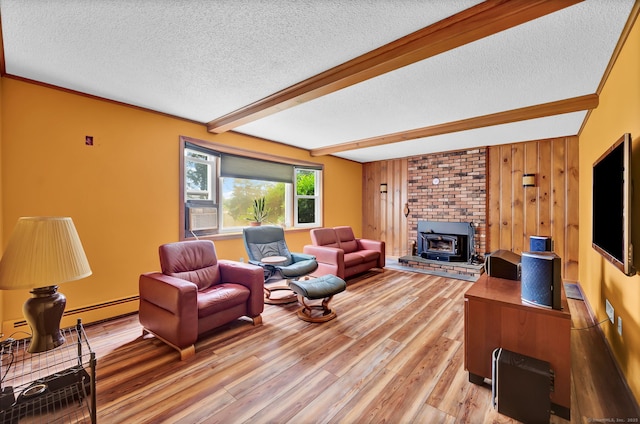 186 Wood Pond Rd, South Windsor, CT 06074 - living room featuring a textured ceiling, a wood stove, light wood-type flooring, beamed ceiling, and baseboard heating