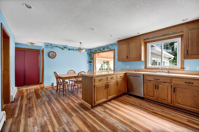 186 Wood Pond Rd, South Windsor, CT 06074 - kitchen featuring stainless steel dishwasher, a peninsula, a textured ceiling, brown cabinetry, and light wood-style flooring