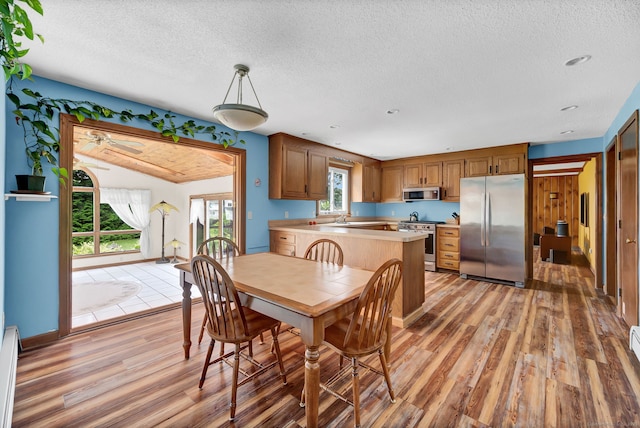 186 Wood Pond Rd, South Windsor, CT 06074 - dining room featuring light wood-type flooring, a textured ceiling, and a ceiling fan