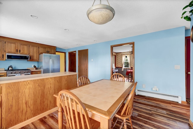 186 Wood Pond Rd, South Windsor, CT 06074 - dining space featuring baseboard heating and wood finished floors