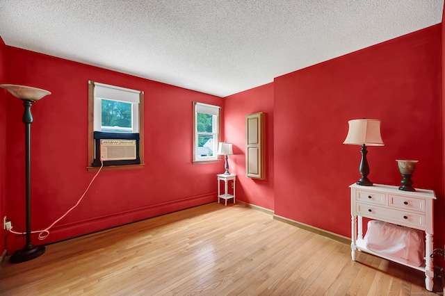 186 Wood Pond Rd, South Windsor, CT 06074 - empty room featuring a textured ceiling, hardwood / wood-style floors, and cooling unit