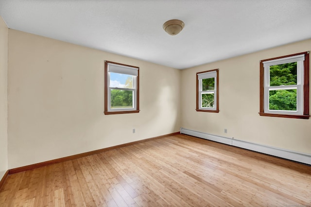 186 Wood Pond Rd, South Windsor, CT 06074 - spare room featuring plenty of natural light, hardwood / wood-style flooring, and a baseboard heating unit