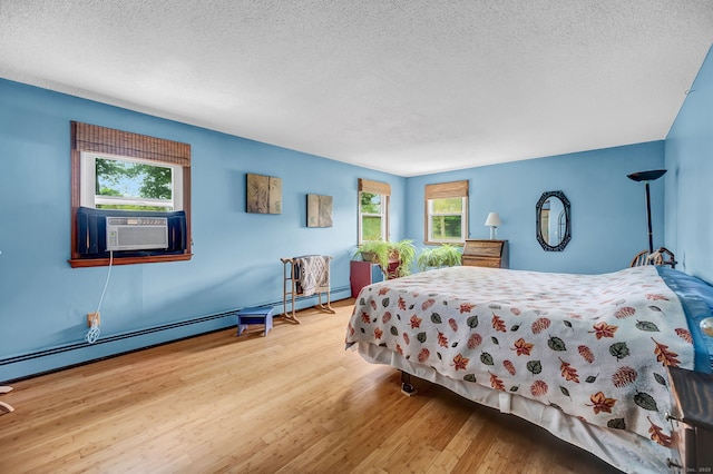 186 Wood Pond Rd, South Windsor, CT 06074 - bedroom featuring a textured ceiling, cooling unit, and wood finished floors