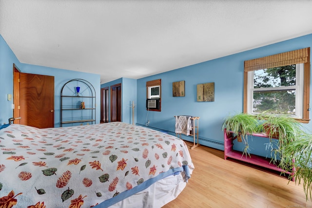 186 Wood Pond Rd, South Windsor, CT 06074 - bedroom with wood finished floors, a closet, and cooling unit