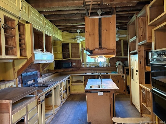 109 Clay St, Thomaston, CT 06787 - kitchen featuring a ceiling fan, an island with sink, dark wood finished floors, and light countertops