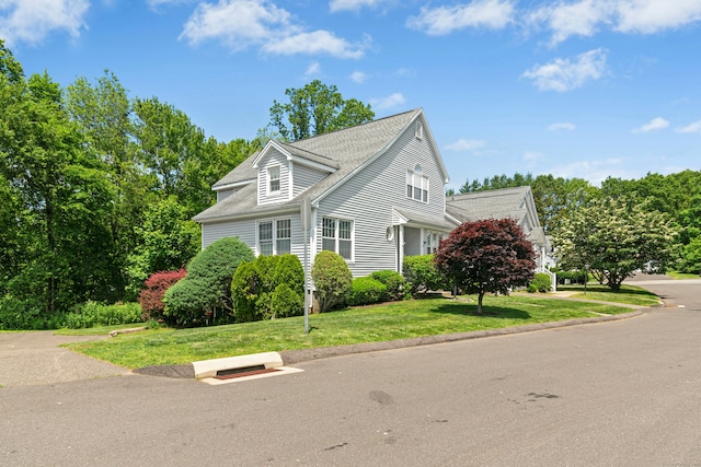 376 Woodridge Unit 376, Shelton, CT 06484 - view of property exterior with a yard and a shingled roof