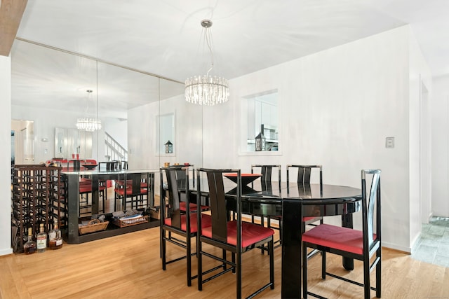 376 Woodridge Unit 376, Shelton, CT 06484 - dining area featuring a chandelier, wood finished floors, and stairway