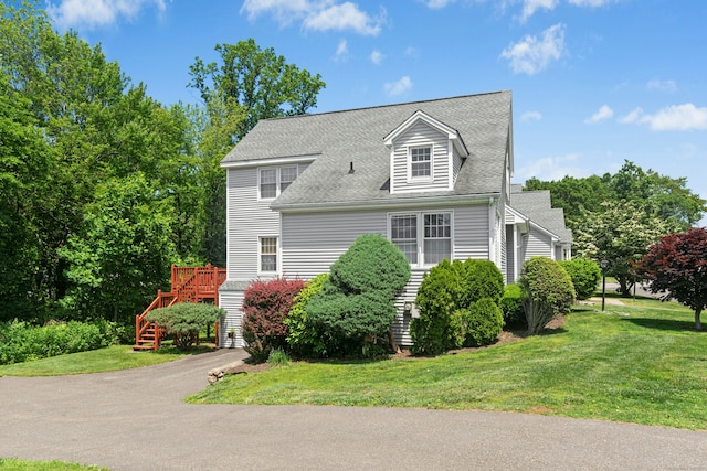 376 Woodridge Unit 376, Shelton, CT 06484 - view of front of house with stairway, a front lawn, a shingled roof, and a deck