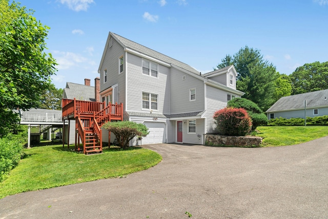 376 Woodridge Unit 376, Shelton, CT 06484 - view of front of house featuring stairs, driveway, a garage, a wooden deck, and a front lawn
