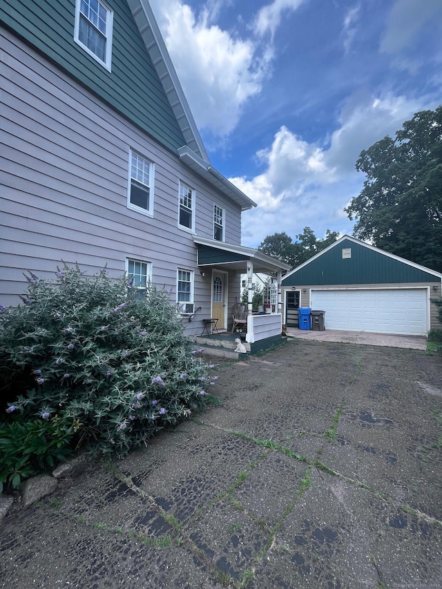 9 Starkweather St, Manchester, CT 06042 - view of front of property featuring covered porch, a detached garage, and an outdoor structure