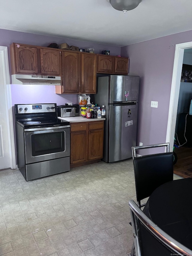 9 Starkweather St, Manchester, CT 06042 - kitchen with appliances with stainless steel finishes, under cabinet range hood, light countertops, and brown cabinets