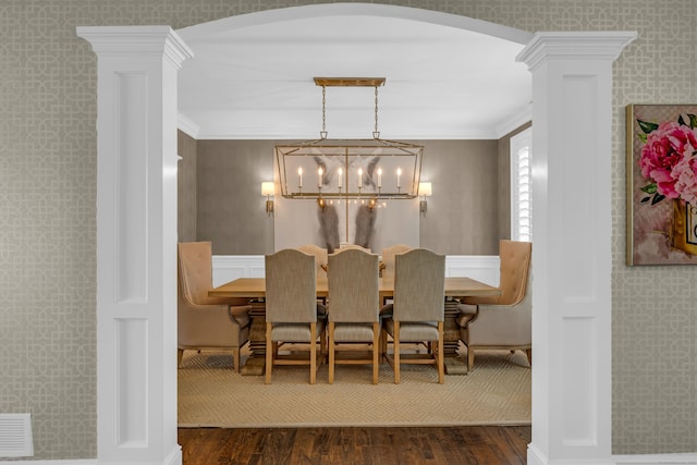 8 Jacob Ln, Killingworth, CT 06419 - dining space with dark wood-type flooring, arched walkways, decorative columns, a chandelier, and crown molding